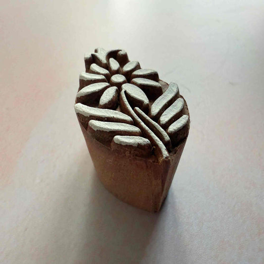 Wooden stamp with floral design on a white background