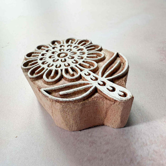 Wooden stamp with floral design on a light background