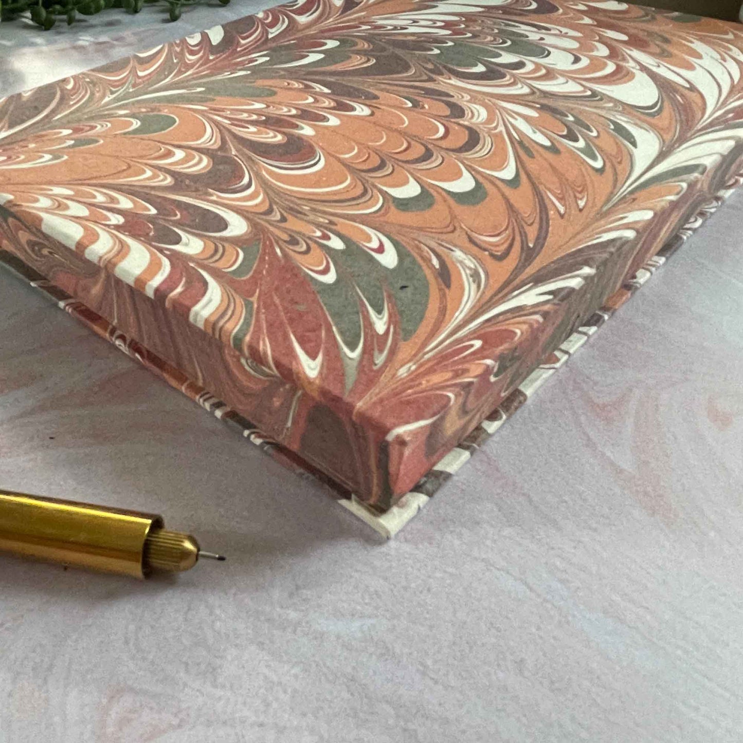 Hand marbled hardcover notebook made from recycled cotton paper. Red and coral A5 notebook