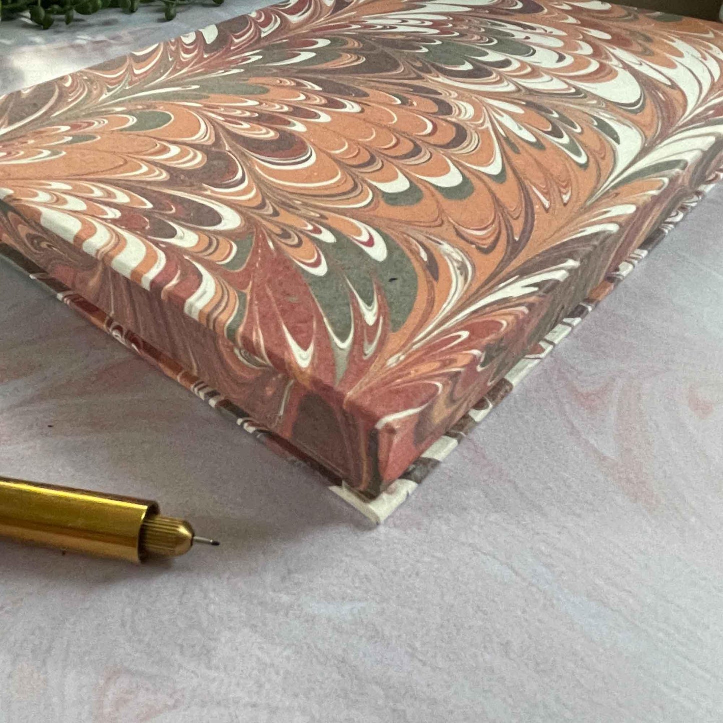 Hand marbled hardcover notebook made from recycled cotton paper. Red and coral A5 notebook