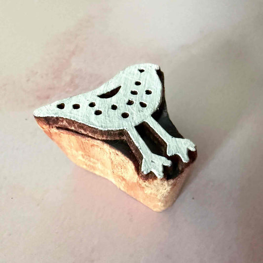 Wooden stamp with a bird design on a light background