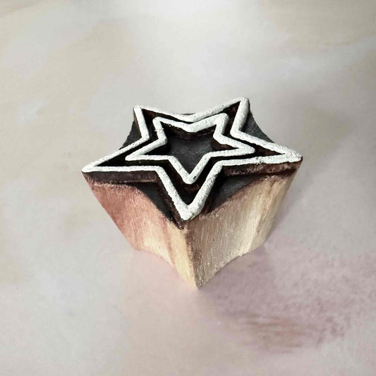 Wooden stamp with star design on a light background