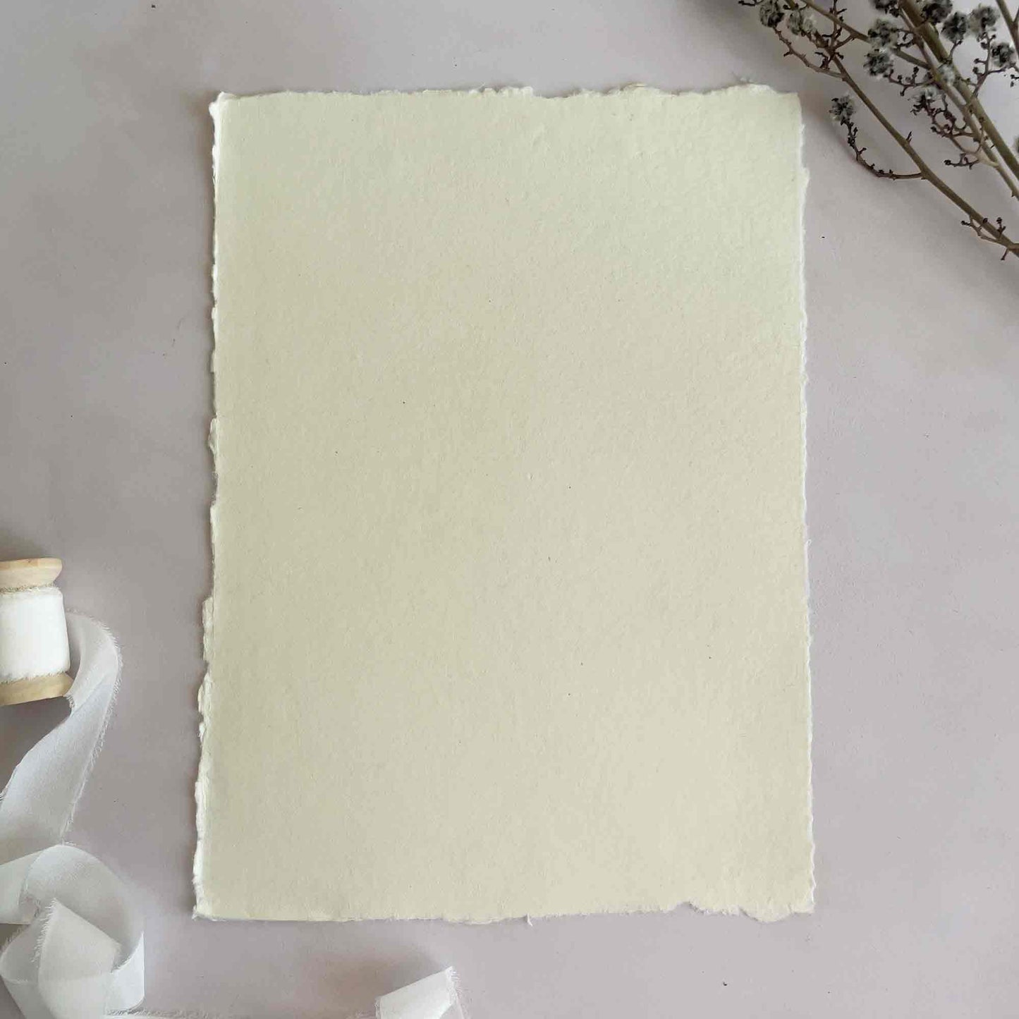 A4 sheets of handmade cotton rag paper in cream. Deckle edge paper by The Natural Paper Company
