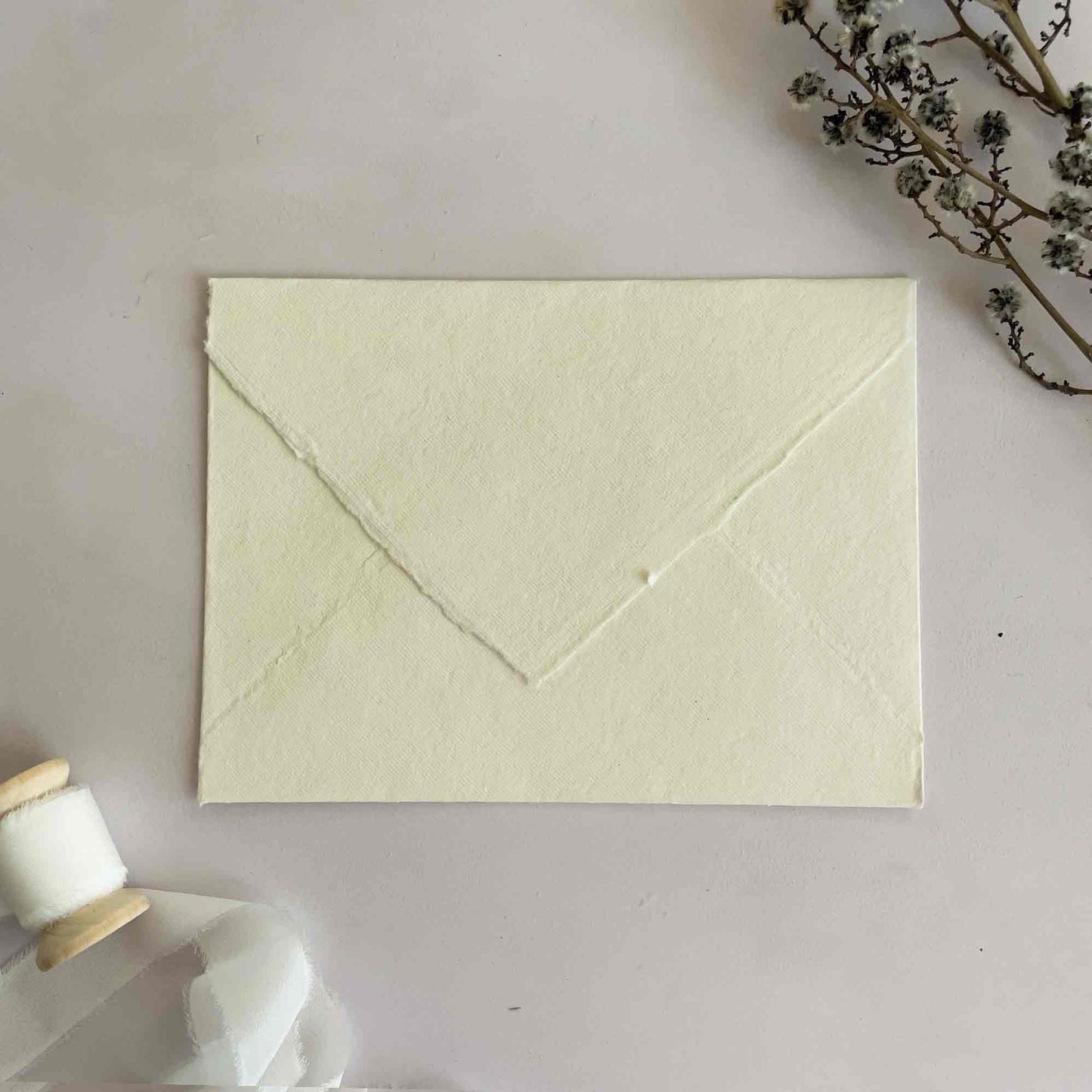 Cream handmade paper envelopes with deckled edges. Invitation envelopes made from cotton rag paper. By The Natural Paper Company.