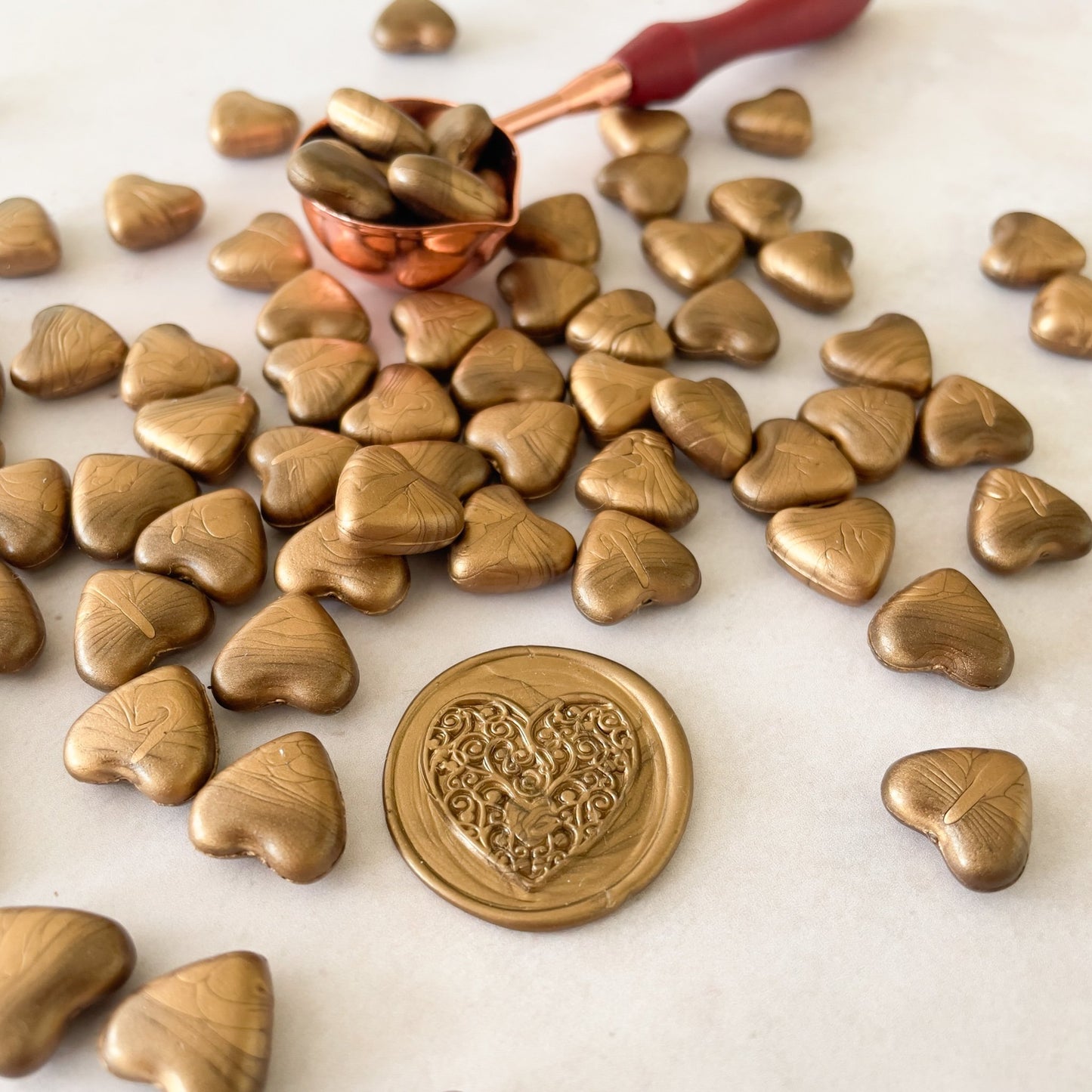 Sealing Wax Beads in Warm Gold .  Small beads of wax to make wax seals in metallic gold colour.  Eco friendly wax to use with a melting spoon and stamp.  by The Natural Paper Company