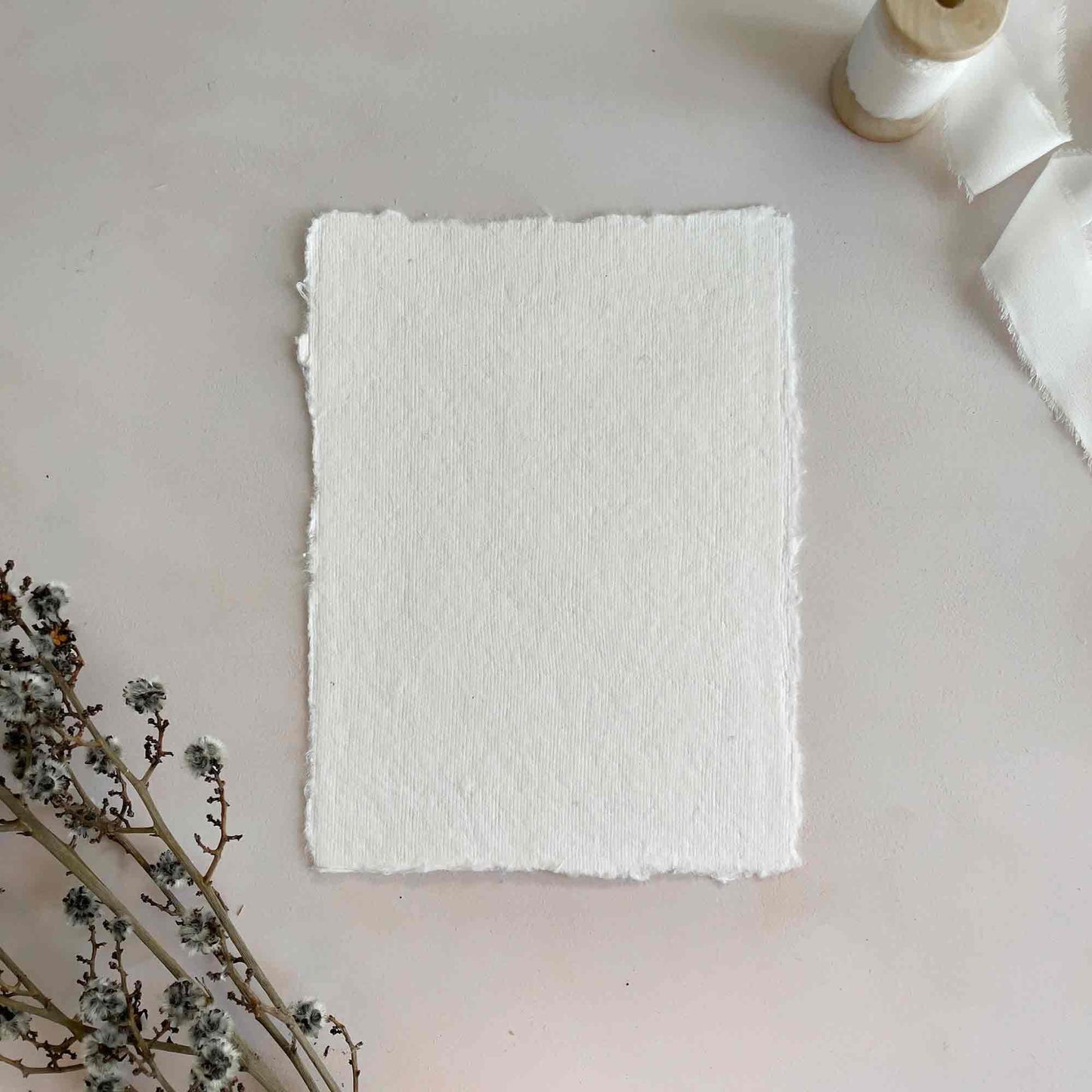 White handmade cotton rag card with deckled edges. By The Natural Paper Company