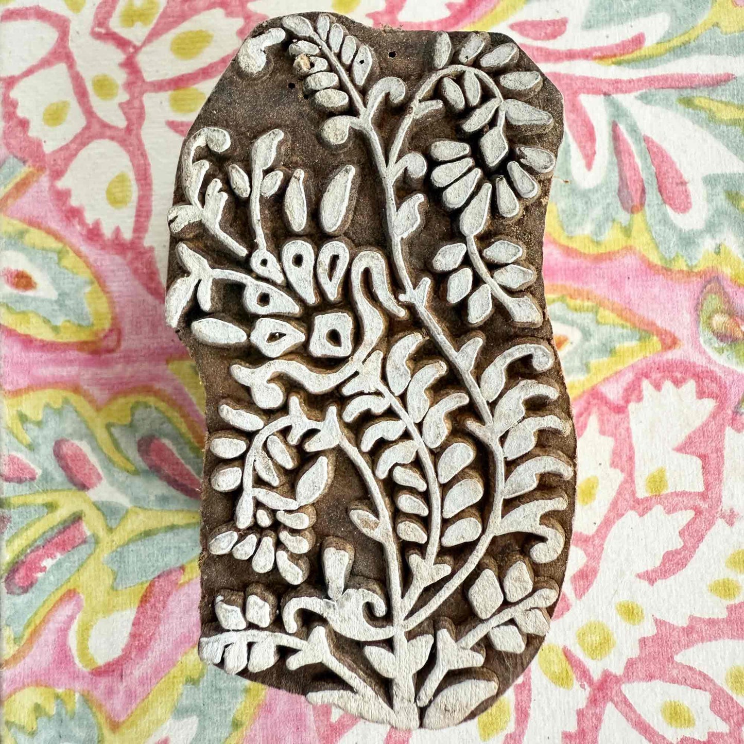 intricate Indian wood block stamp with floral vine pattern