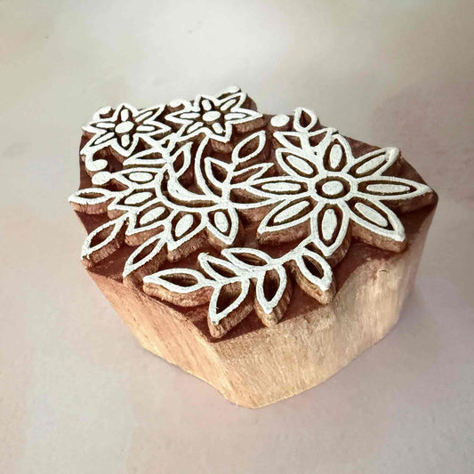 Wooden stamp with floral designs on a light background