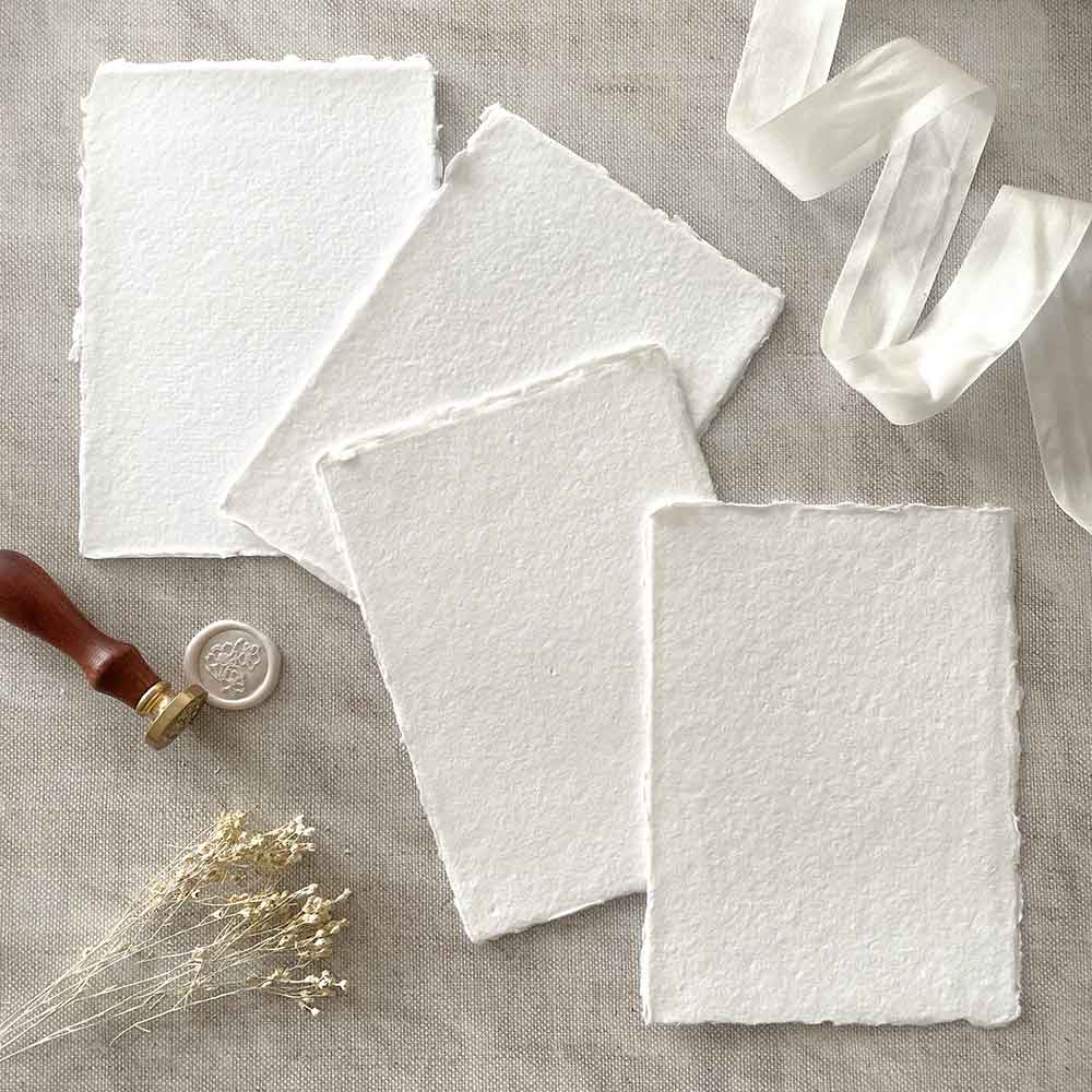 Handmade cotton rag paper in white.  Recycled paper with a deckled edge