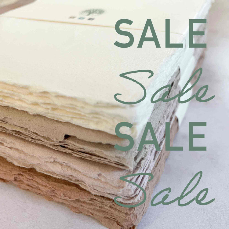 Stack of textured handmade natural paper in off‑white, cream and earthy brown tones — The Natural Paper Company sale