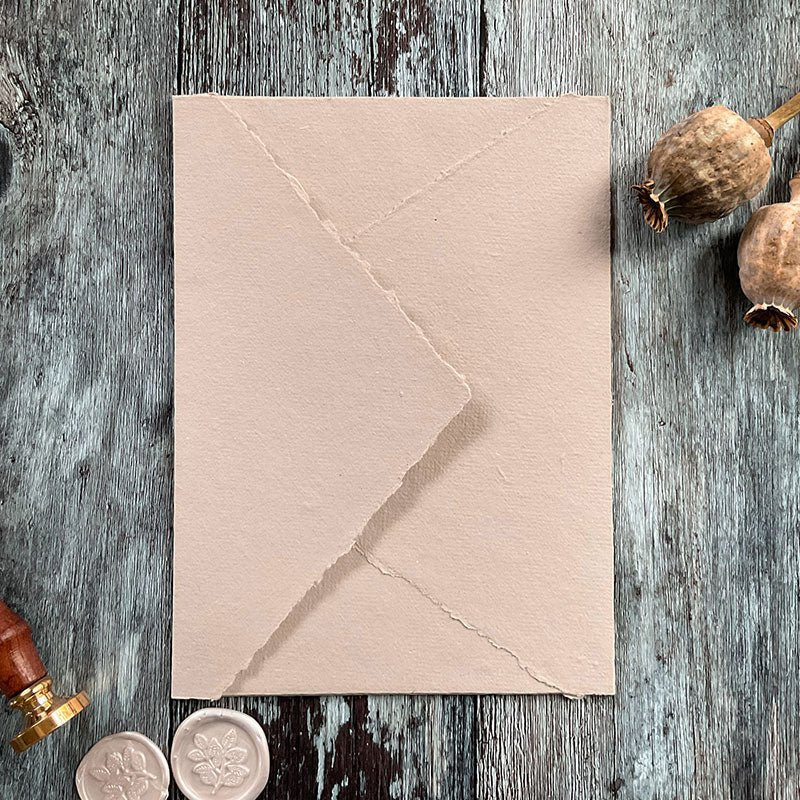 Handmade paper invitation envelope in a natural beige colour.  Recycled envelope with a deckle edge pointed flap.  By The Natural Paper Company