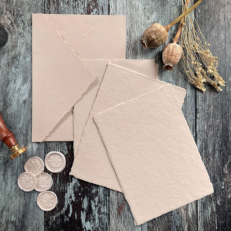 Beige handmade paper and envelope with a deckle edge.  Handmade recycled cotton rag paper.  Perfect for making invitations and stationery.  Tree free and Vegan Paper.  By The Natural Paper Company