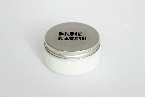 Pot of opaque white ink for printing with Indian wood block stamps
