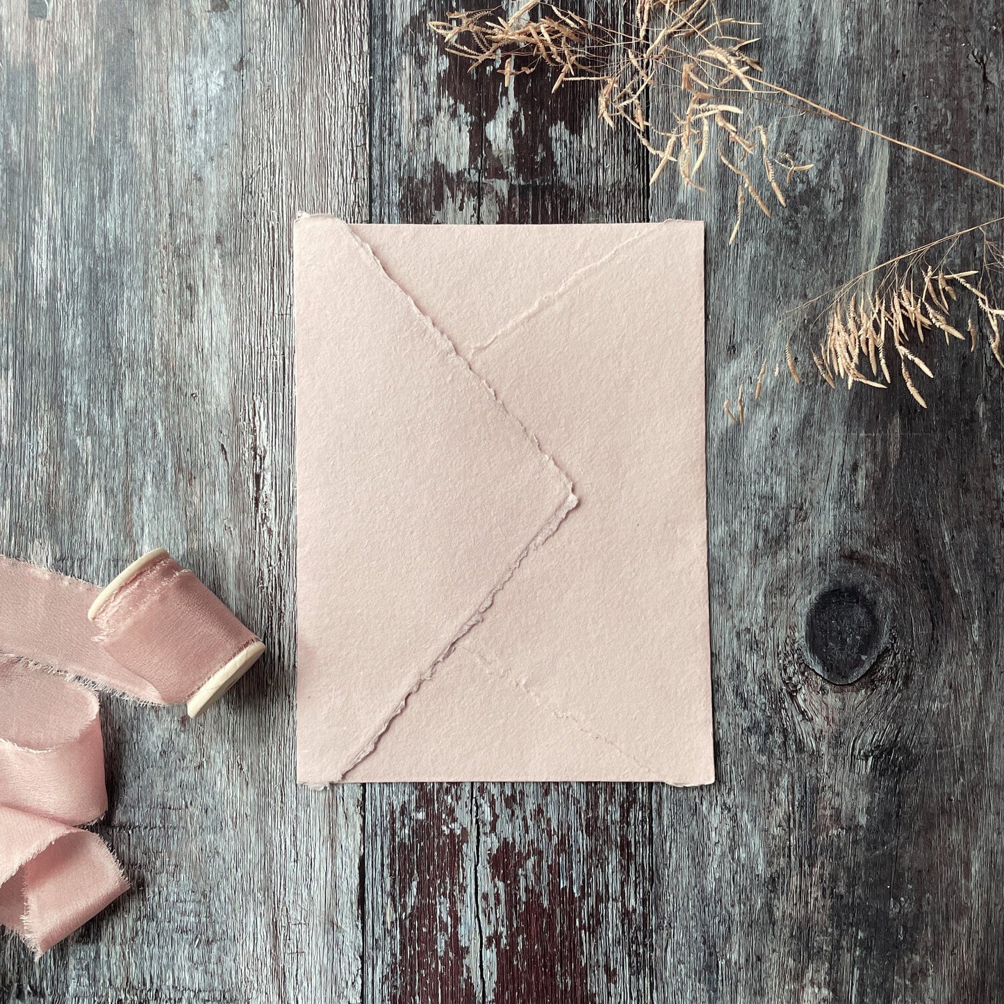 5x7 invitation envelope made from blush pink handmade paper.  Deckled edge envelopes made from recycled cotton rag fibres.  By The Natural Paper Company