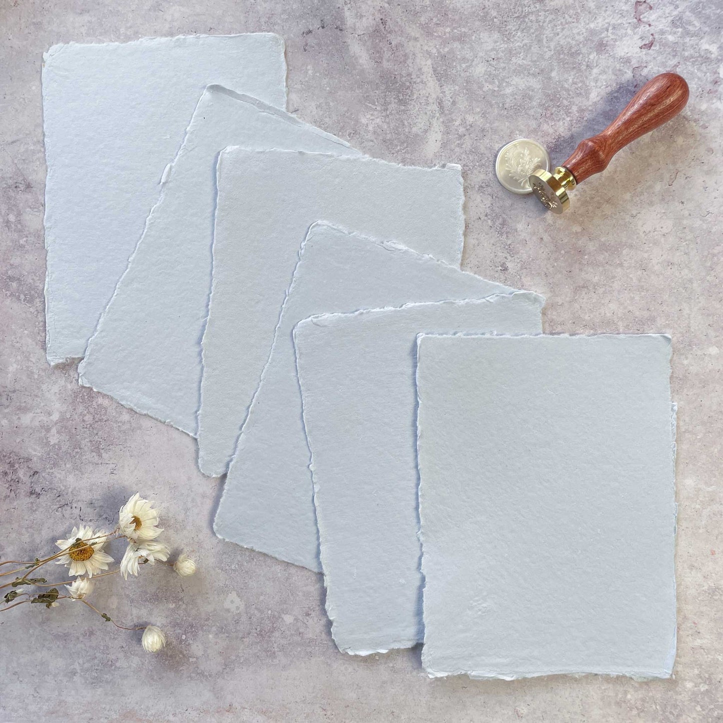 5 x  sheets of handmade cotton rag paper and card with a deckled edge.  Light blue recycled paper made traditionally.  by The Natural Paper Company