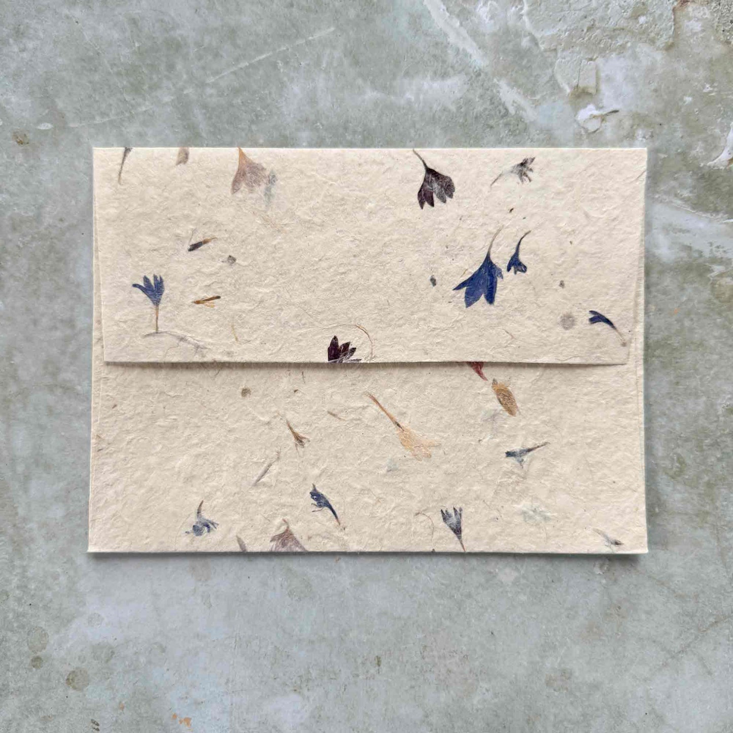 5"x7" invitation envelopes made from handmade lokta paper with corn flower petals