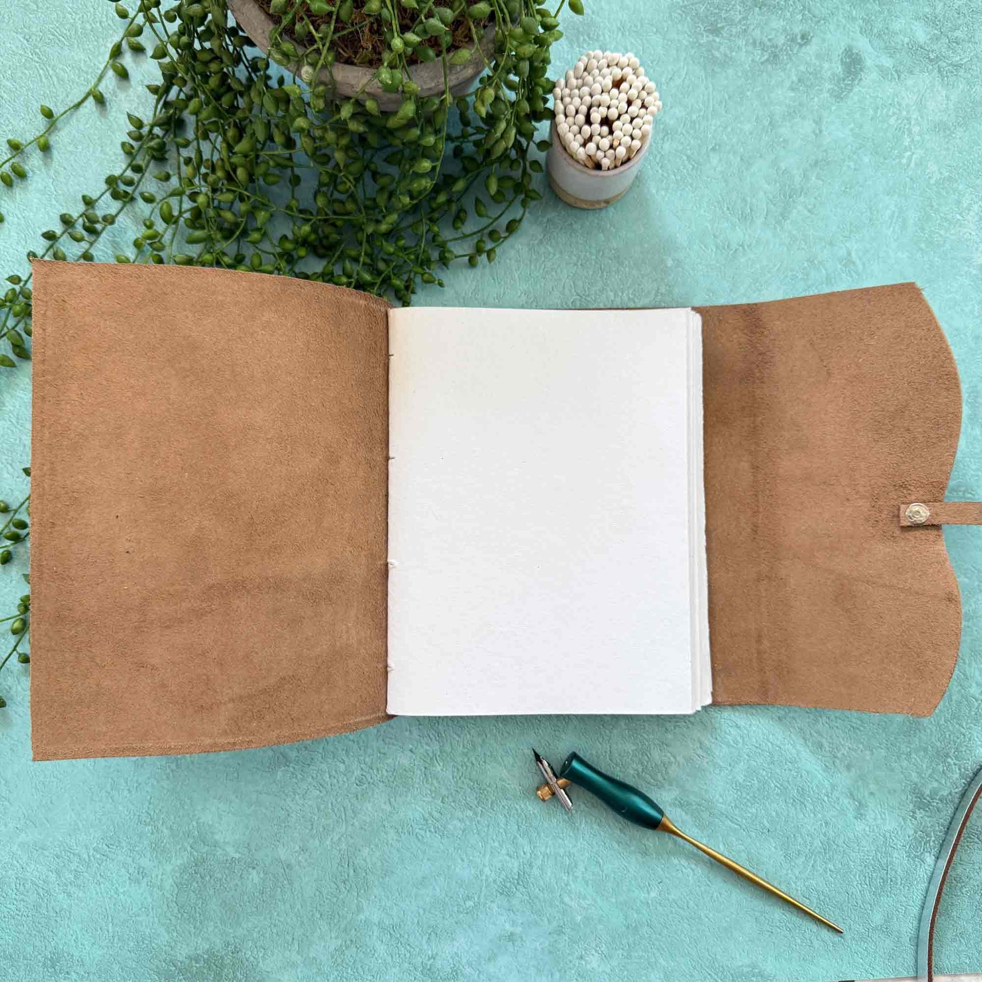 Handmade leather notebook with blank pages and tie