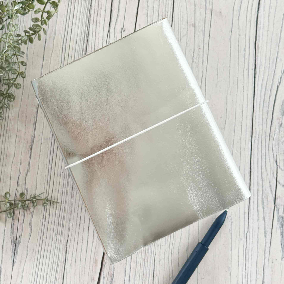 A5 refillable leather journal in metallic silver with matching elastic closure