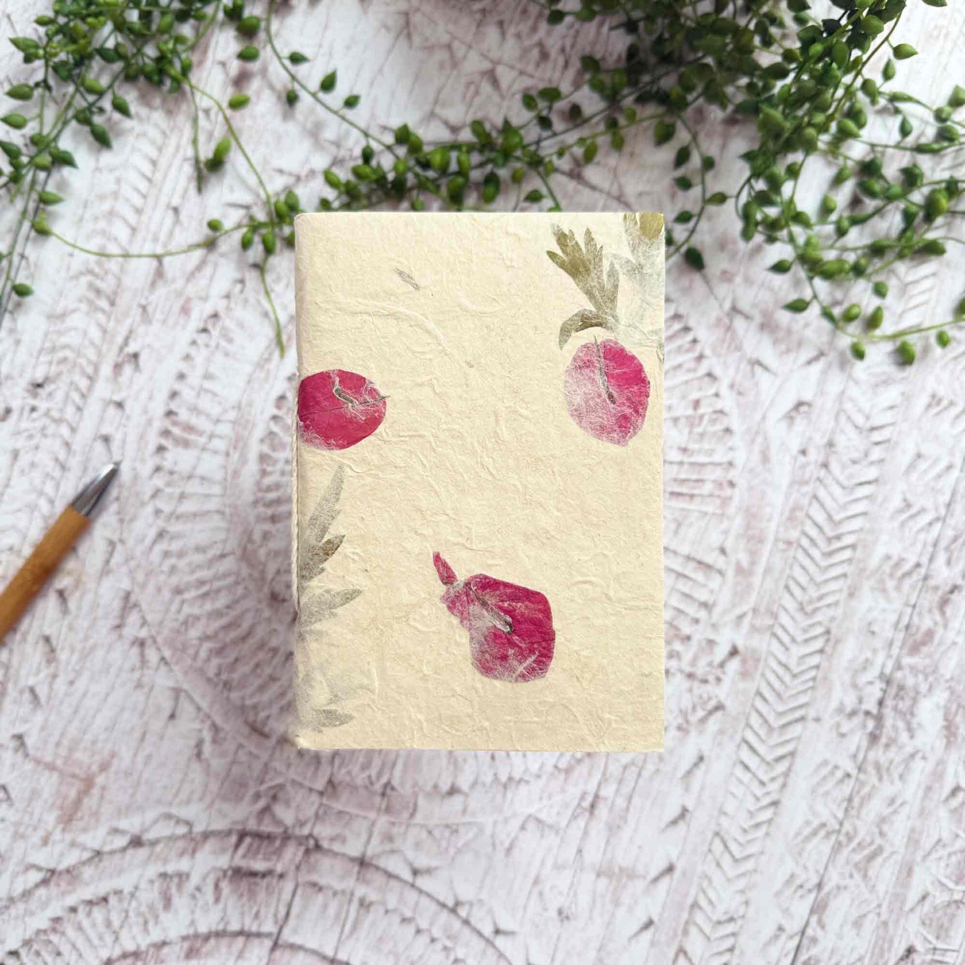 A6 botanical Lokta notebook, natural cream paper embedded with pressed Mugwort and Bougainvillea, hand‑stitched, tree‑free and eco‑friendly