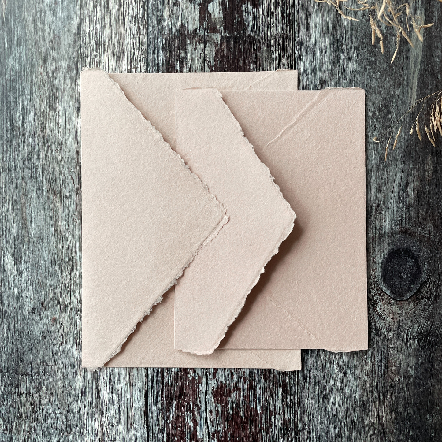 Invitation envelopes made from blush pink handmade paper.  Deckle edge envelopes with a pointed flap.  Handmade invitation envelopes made from recycled cotton rag fibres.  By The Natural Paper Company