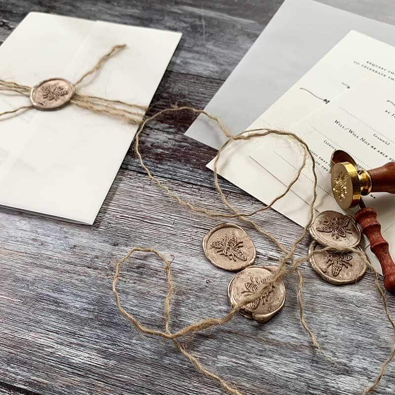 Add natural string to your diy wedding invitations for an on trend rustic look.  DIY wedding invitations made using vellum, a wax seal and flax cord string.