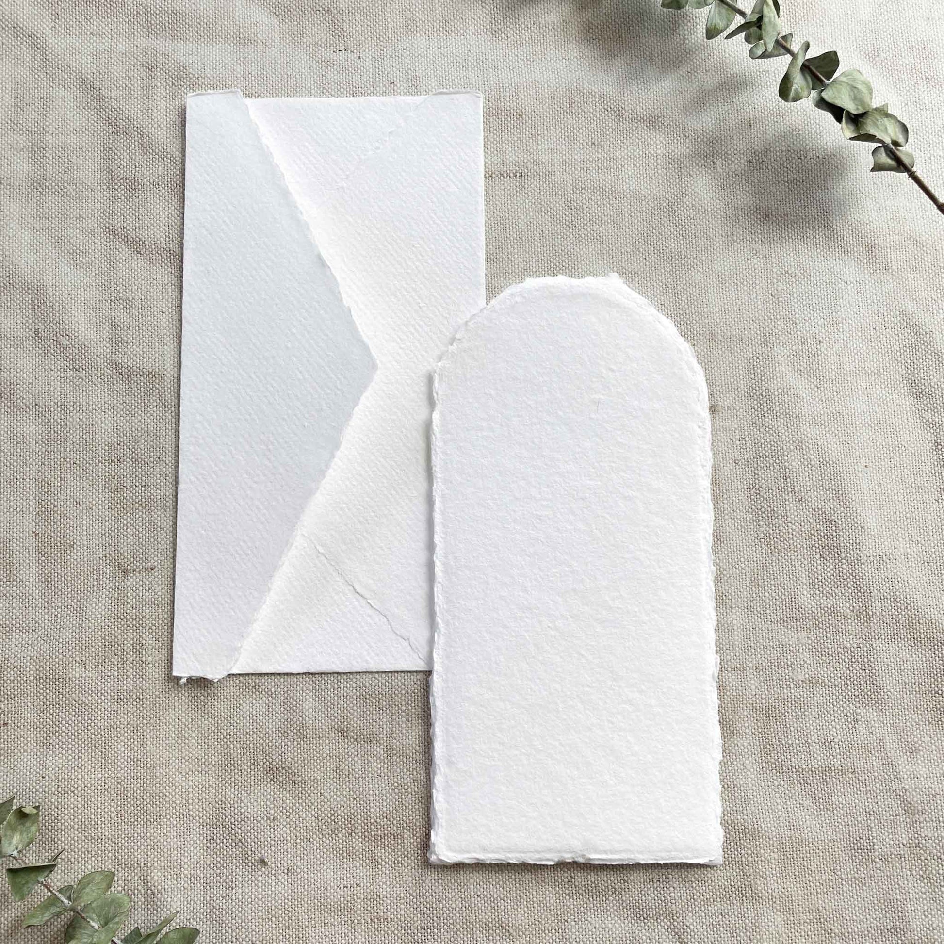 White handmade paper and envelope with a deckled edge.  Arch shaped card made from recycled cotton rag