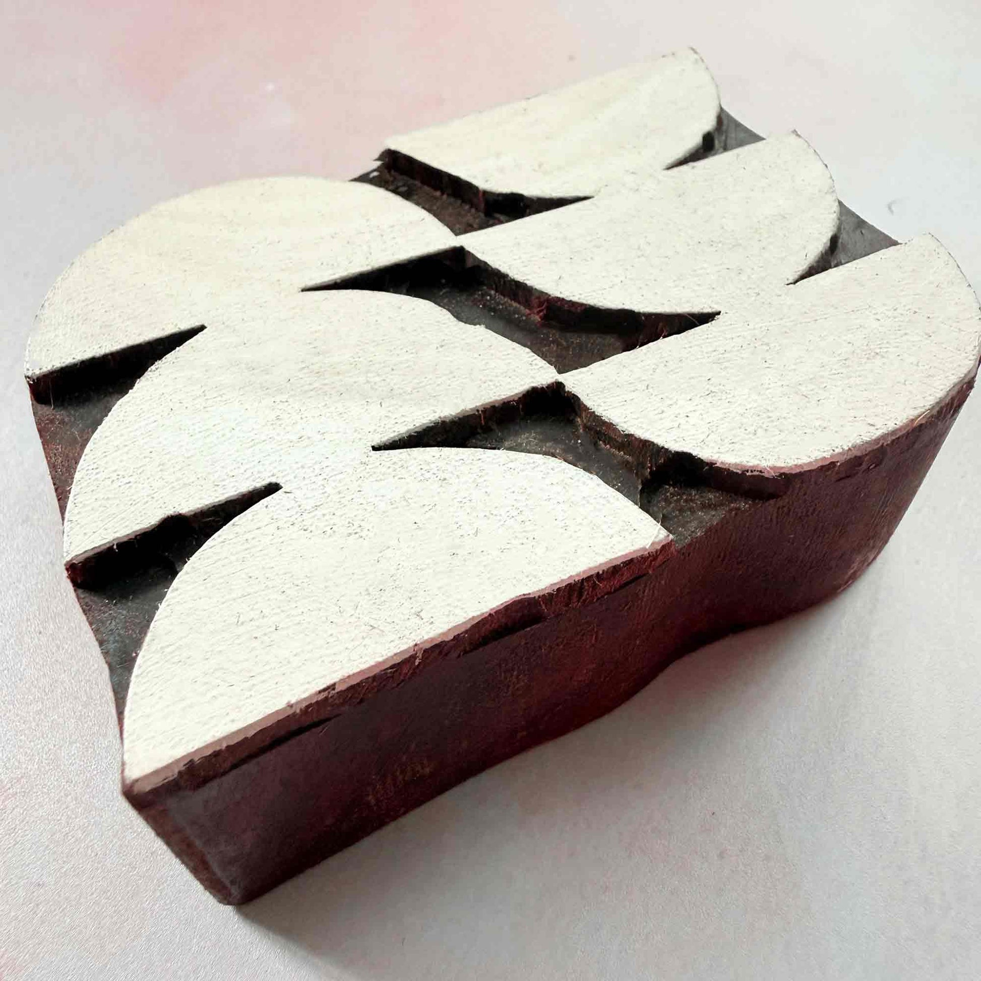 Harmony Indian wood block stamp — curved geometric design viewed from side