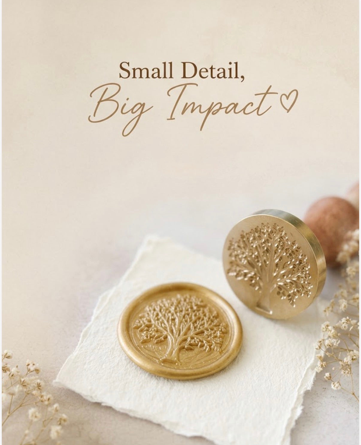 Close-up photograph of a metallic gold wax seal featuring a detailed Tree of Life impression, pressed onto deckle-edged handmade paper. Next to it is the brass stamp head engraved with the same tree design, attached to a smooth wooden handle. Text overlay: “Small Detail, Big Impact”. Warm soft tones with delicate dried flowers, from The Natural Paper Company.