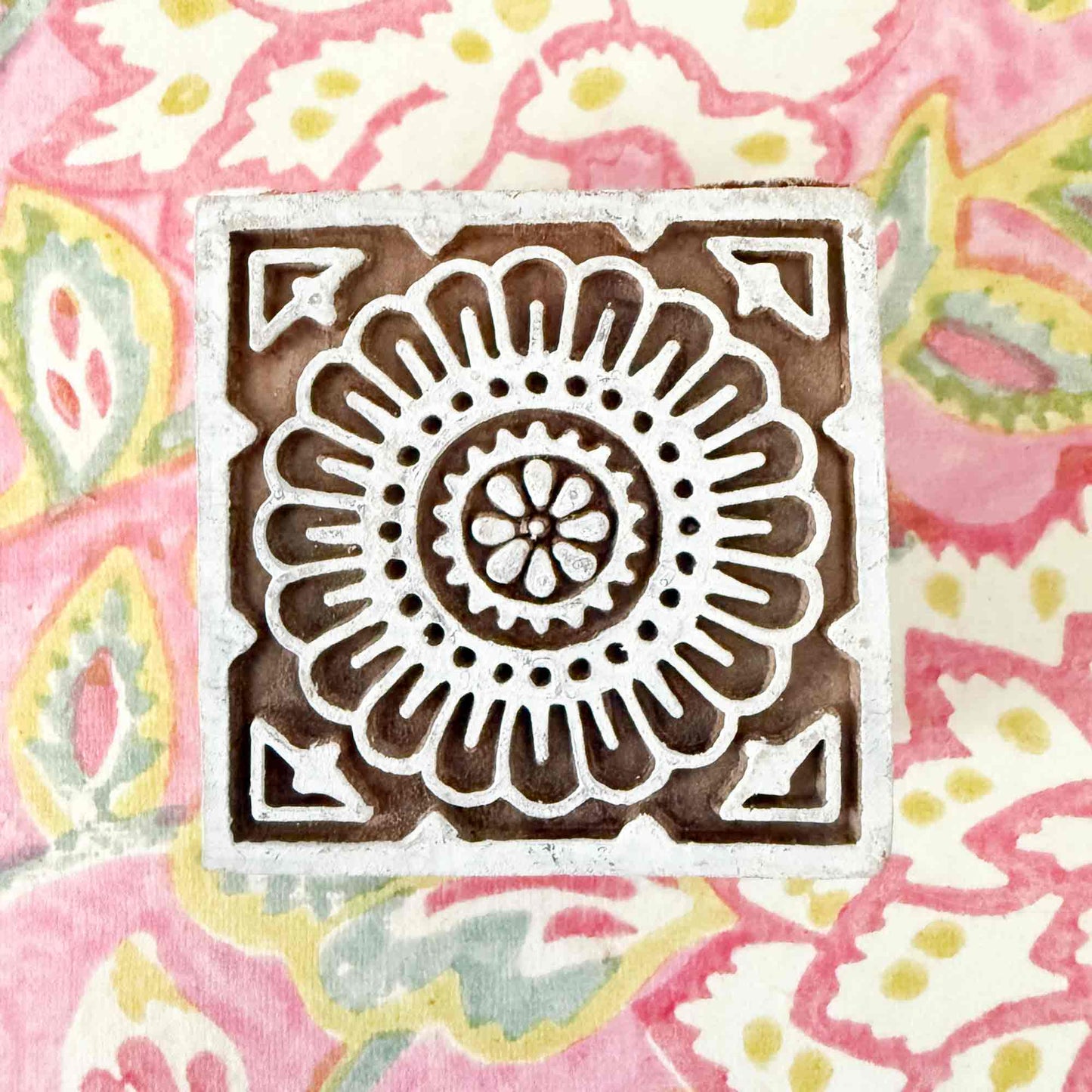 Decorative stamp with a floral tile pattern 