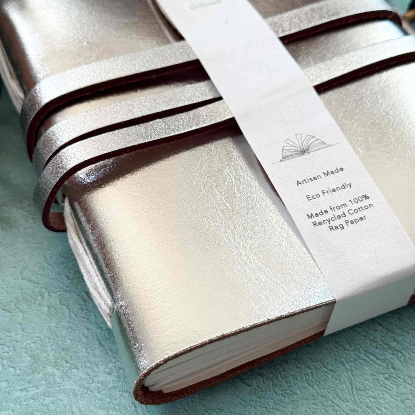 Silver handmade notebook with cotton paper pages.