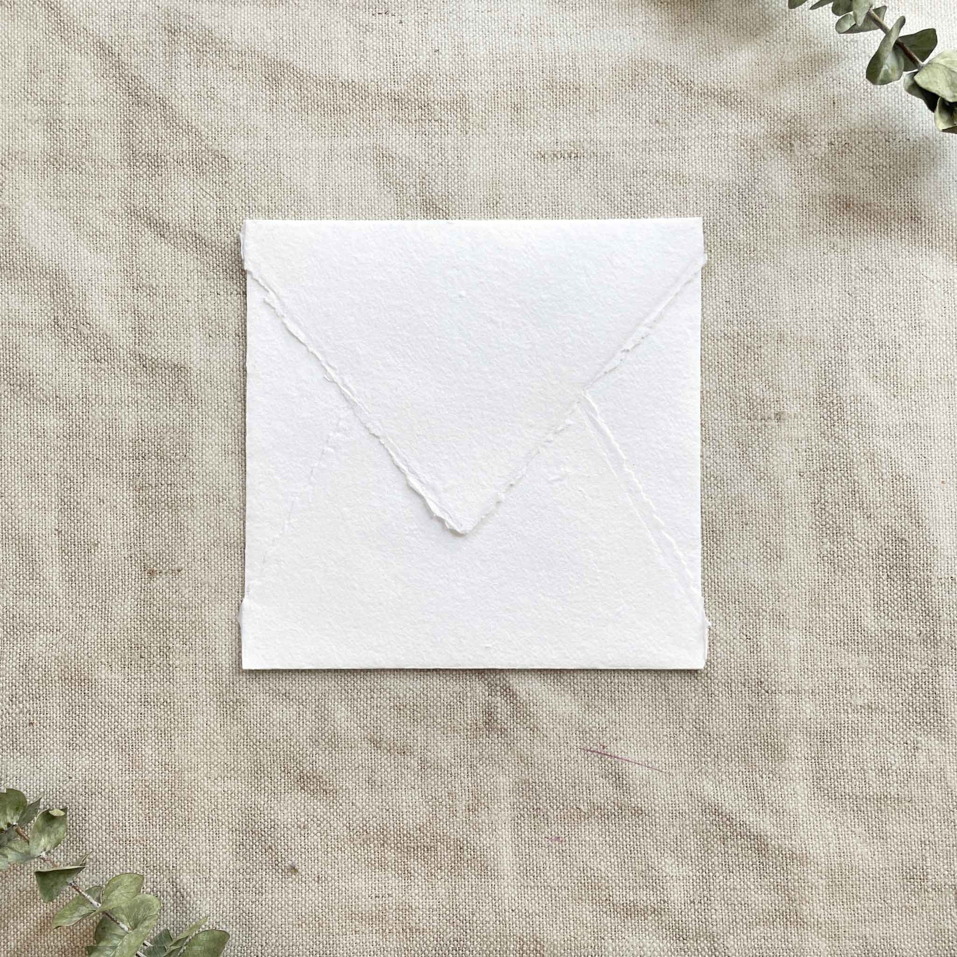 Square envelope made from white handmade cotton rag paper with deckled edges