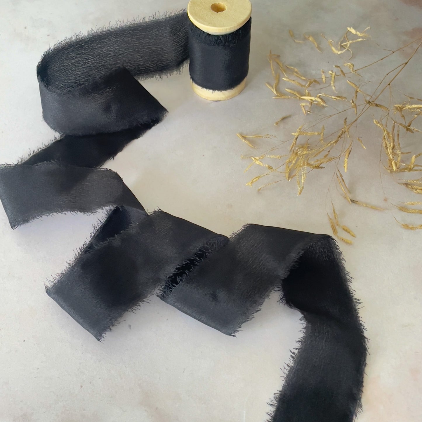 Black Silk Ribbon for crafts.  High quality habotai ribbon with a raw edge.  Decorative ribbon sold on a wooden reel.  By The Natural Paper Company