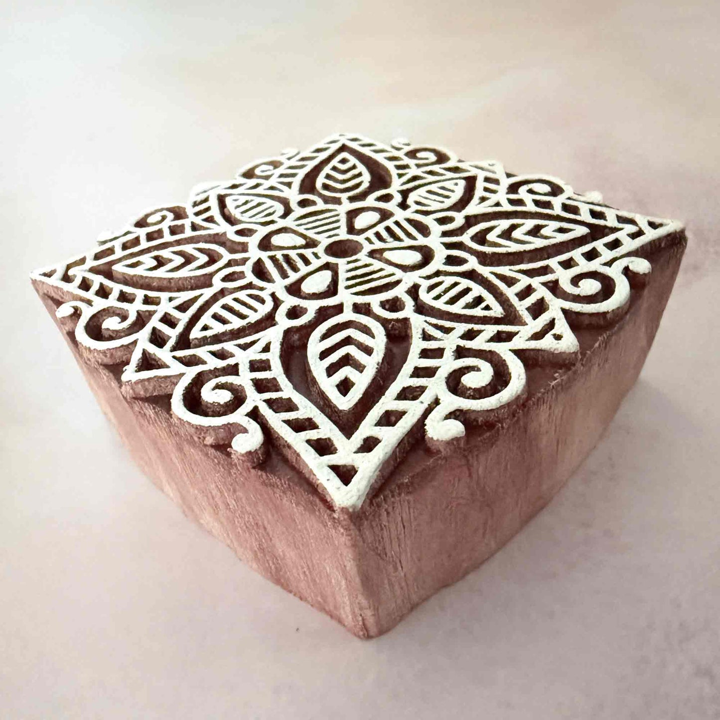 Wooden block stamp with intricate geometric design 