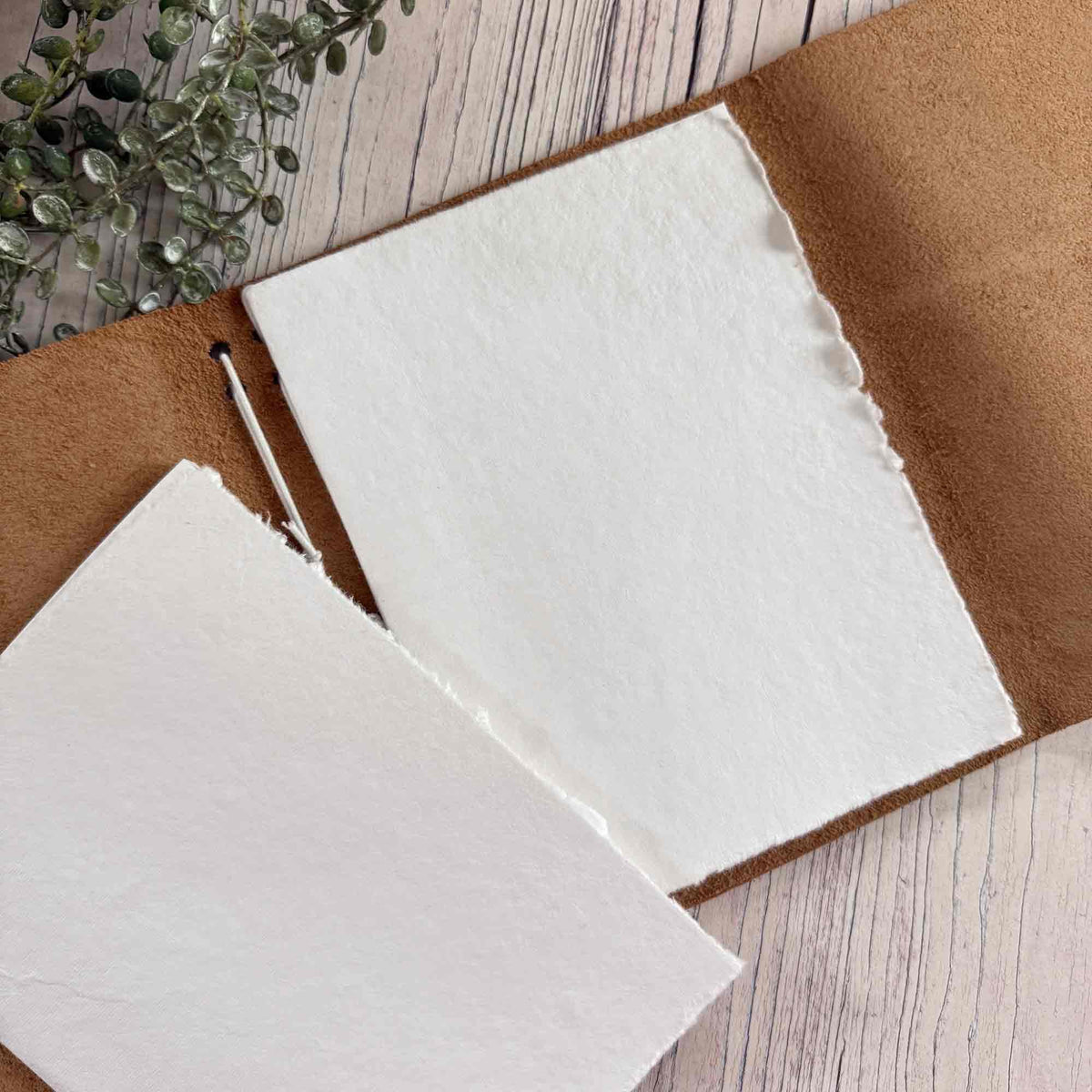 A5 refillable leather notebook showing removable paper inserts and natural suede interior