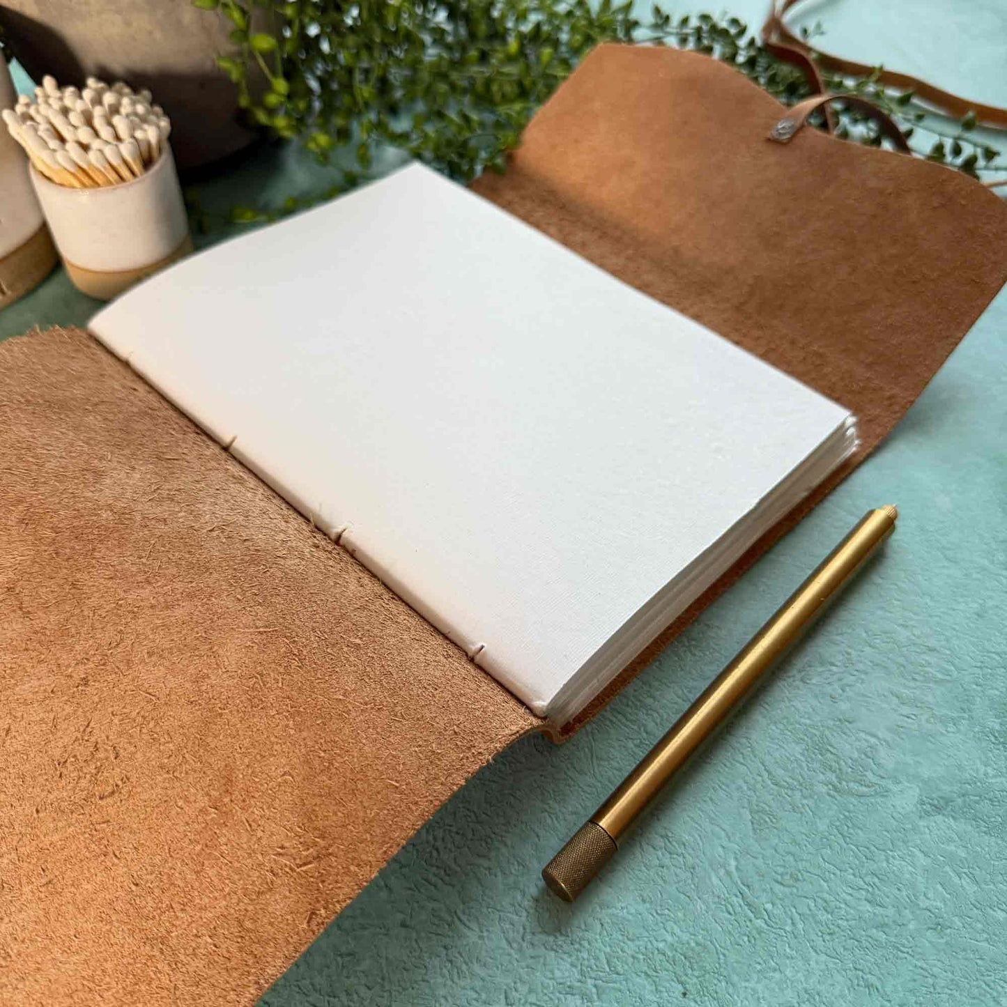 tan leather notebook with blank cotton paper pages.  