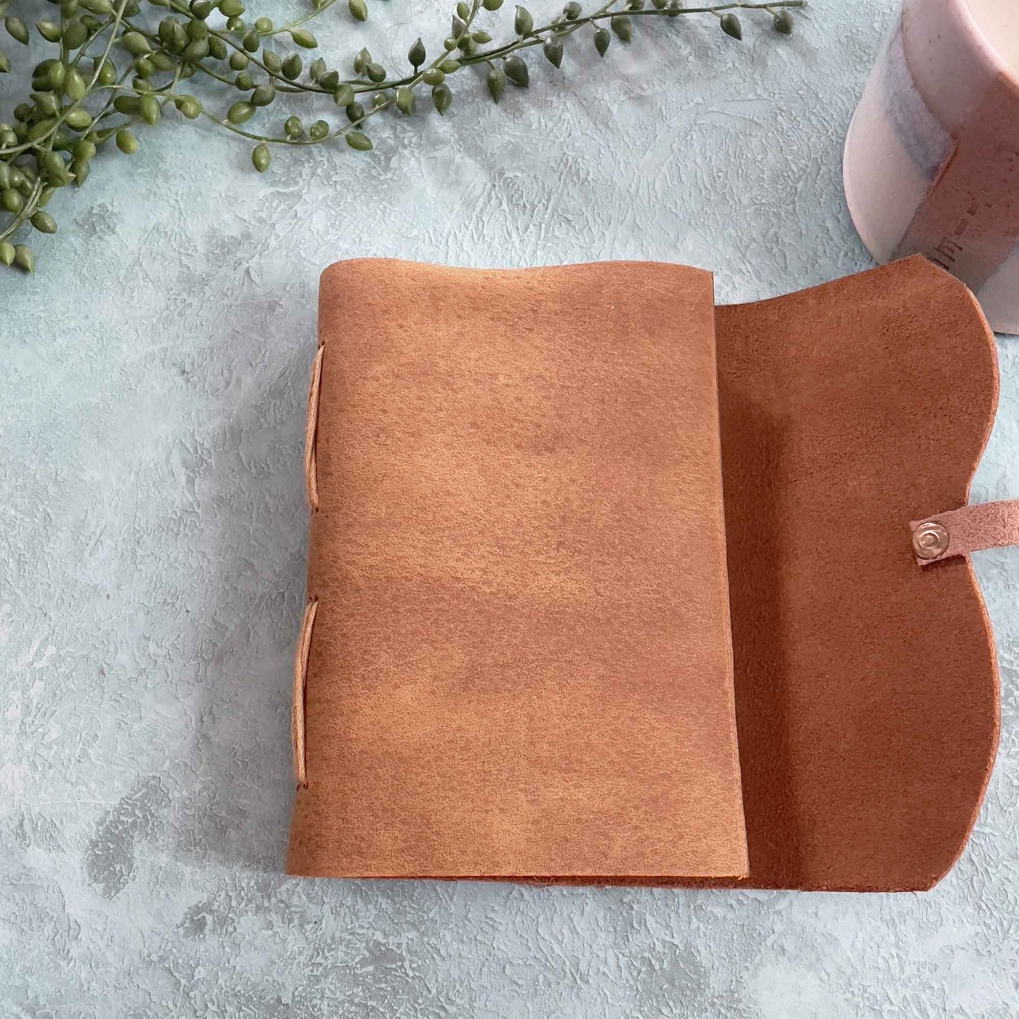 small A6 notebook in tan leather.  Made by hand.