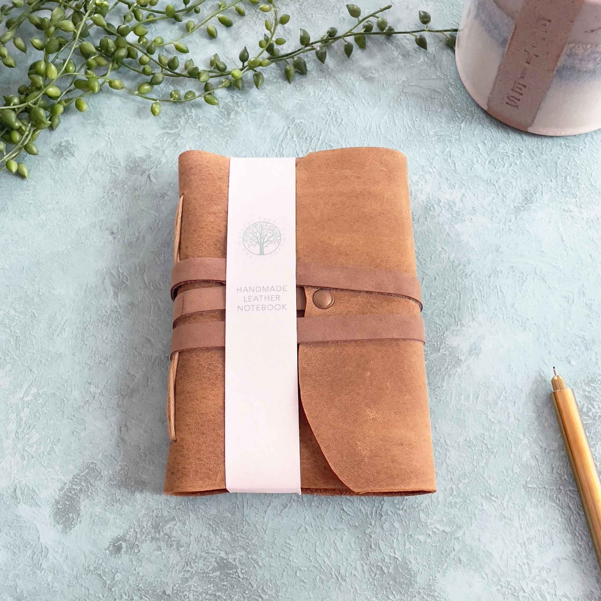 Small A6 handmade leather notebooks in tan.  Made with recycled cotton rag paper pages