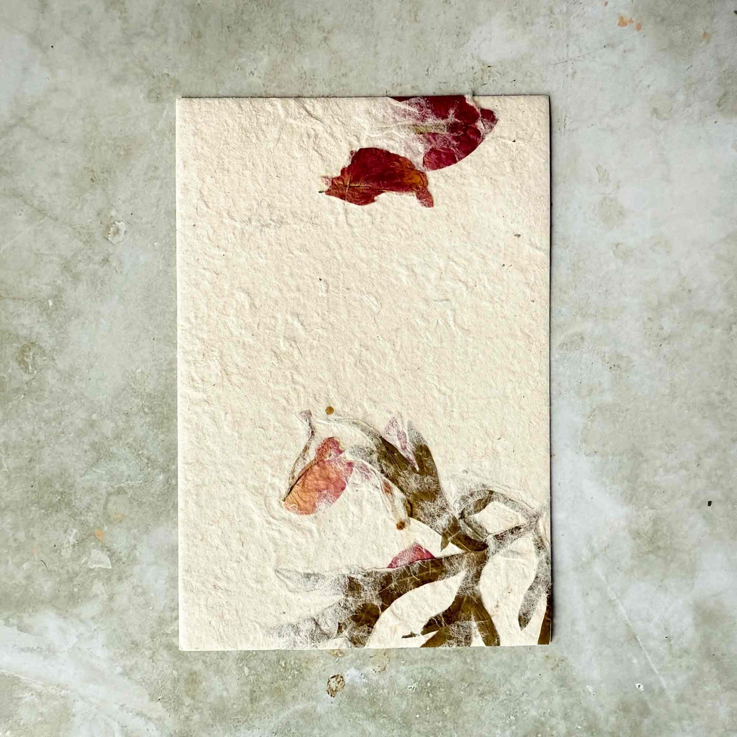 A6 handmade lokta paper card panel with dried mugwort leaves and bougainvillea petals.