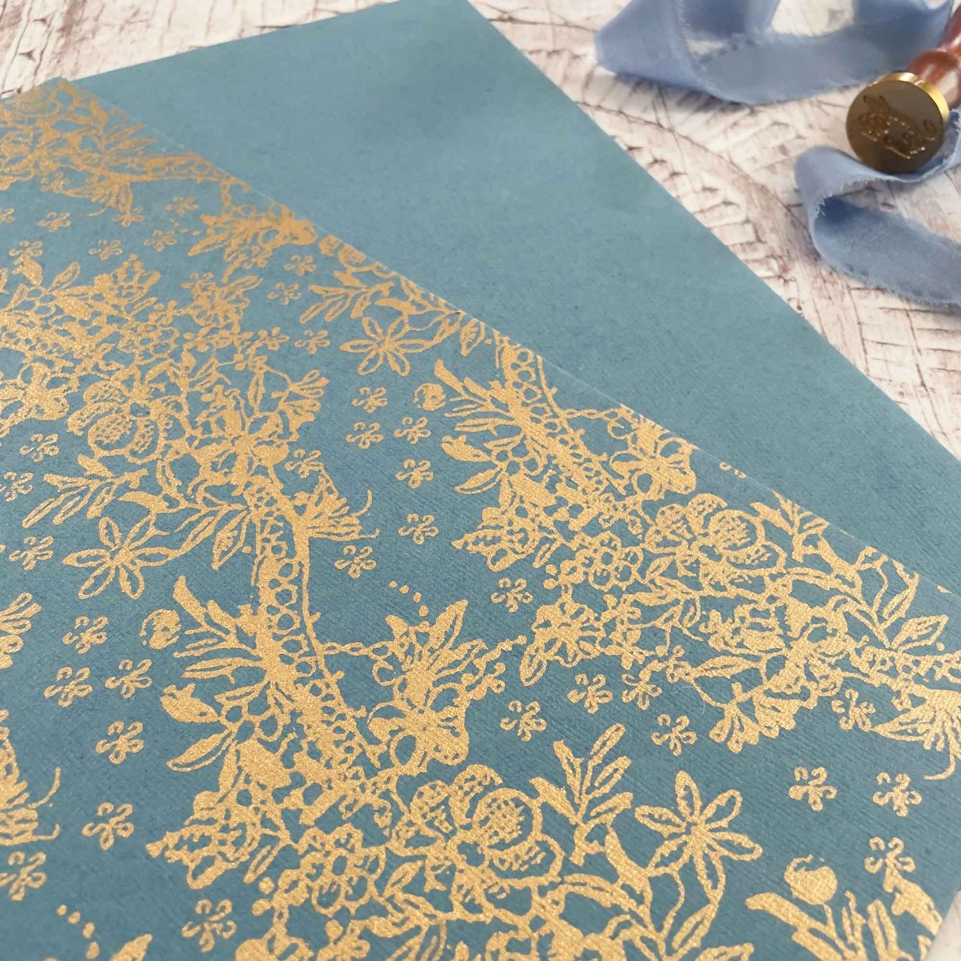 recycled paper in airforce blue with gold pattern