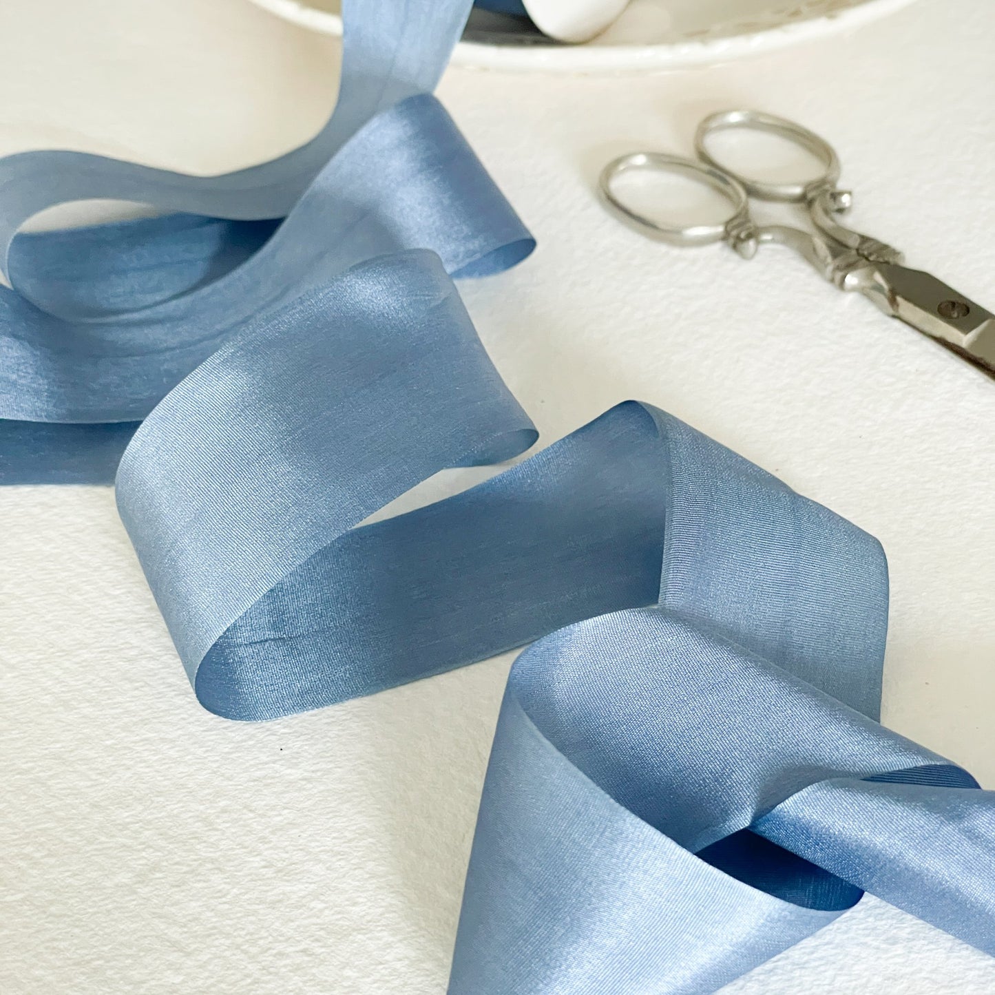 Silk closed edge ribbon in Airforce Blue.  Dusky blue colour fine silk ribbon for crafts.  Sold by the meter.  By The Natural Paper Company