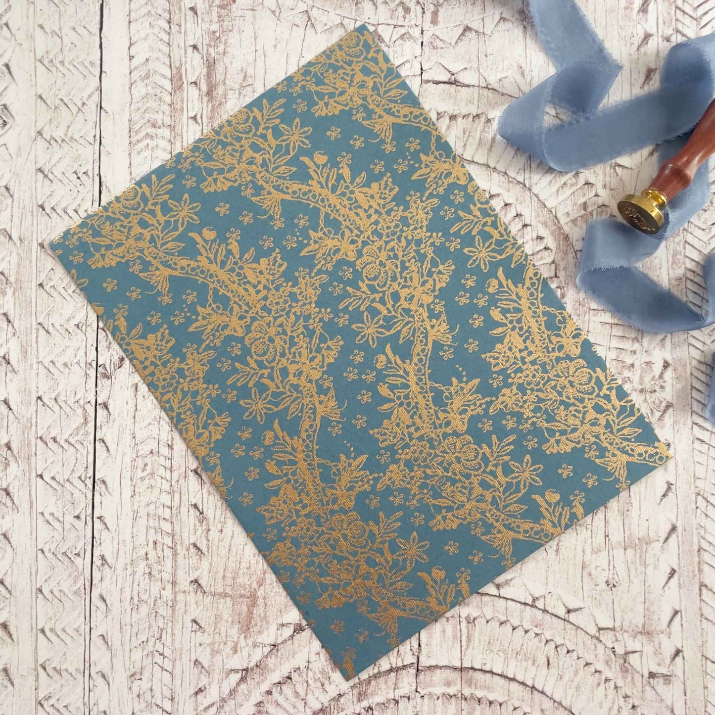 A4 patterned paper made from recycled cotton rag fibres.  Airforce blue and gold