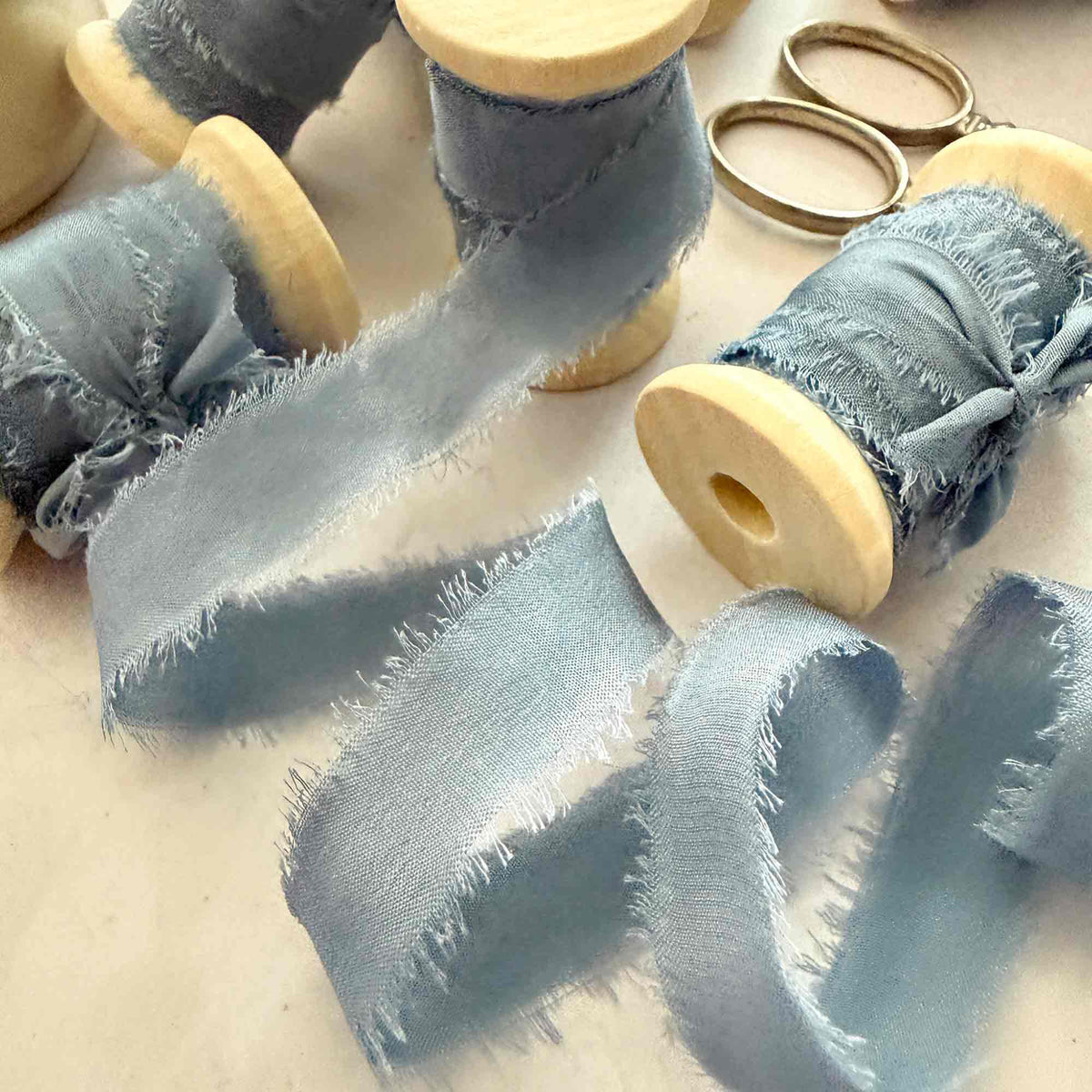 Airforce Blue 10mm Habotai silk ribbon on wooden reels with frayed edges