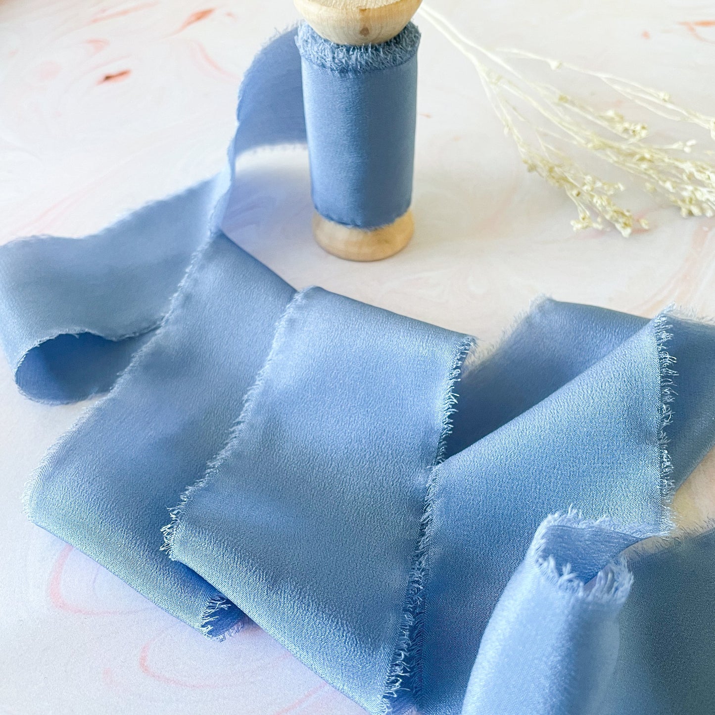 Cornflower blue silk ribbon for floristry and crafts.  Luxury silk ribbon with a frayed edge.  By The Natural Paper Company.