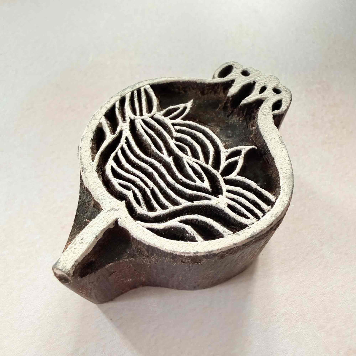 Anar Indian Wood Block Stamp featuring an intricate pomegranate motif with flowing lines, leaves and decorative carved details.