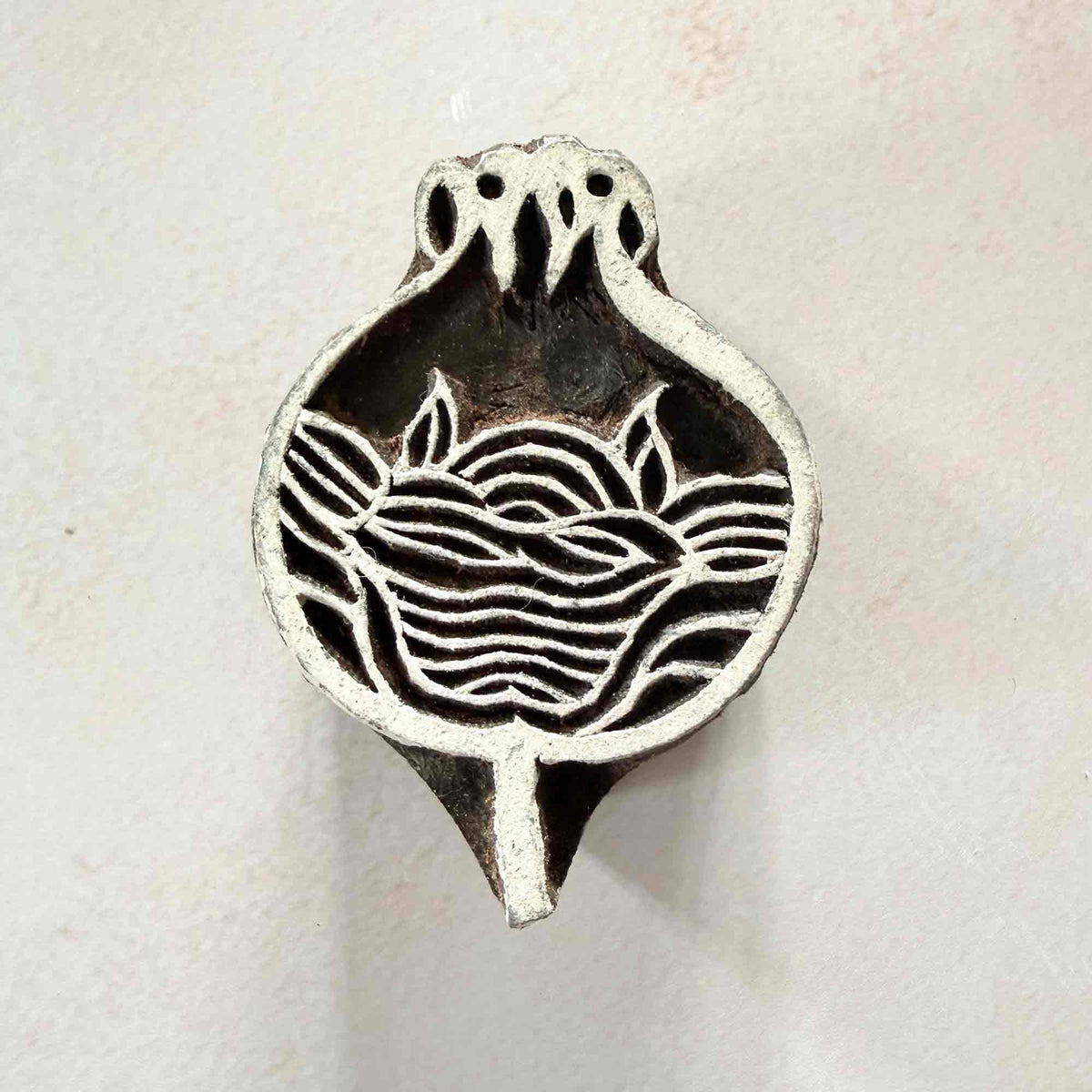 Anar Traditional Printing Block with a detailed pomegranate, curved internal lines and small botanical leaves.