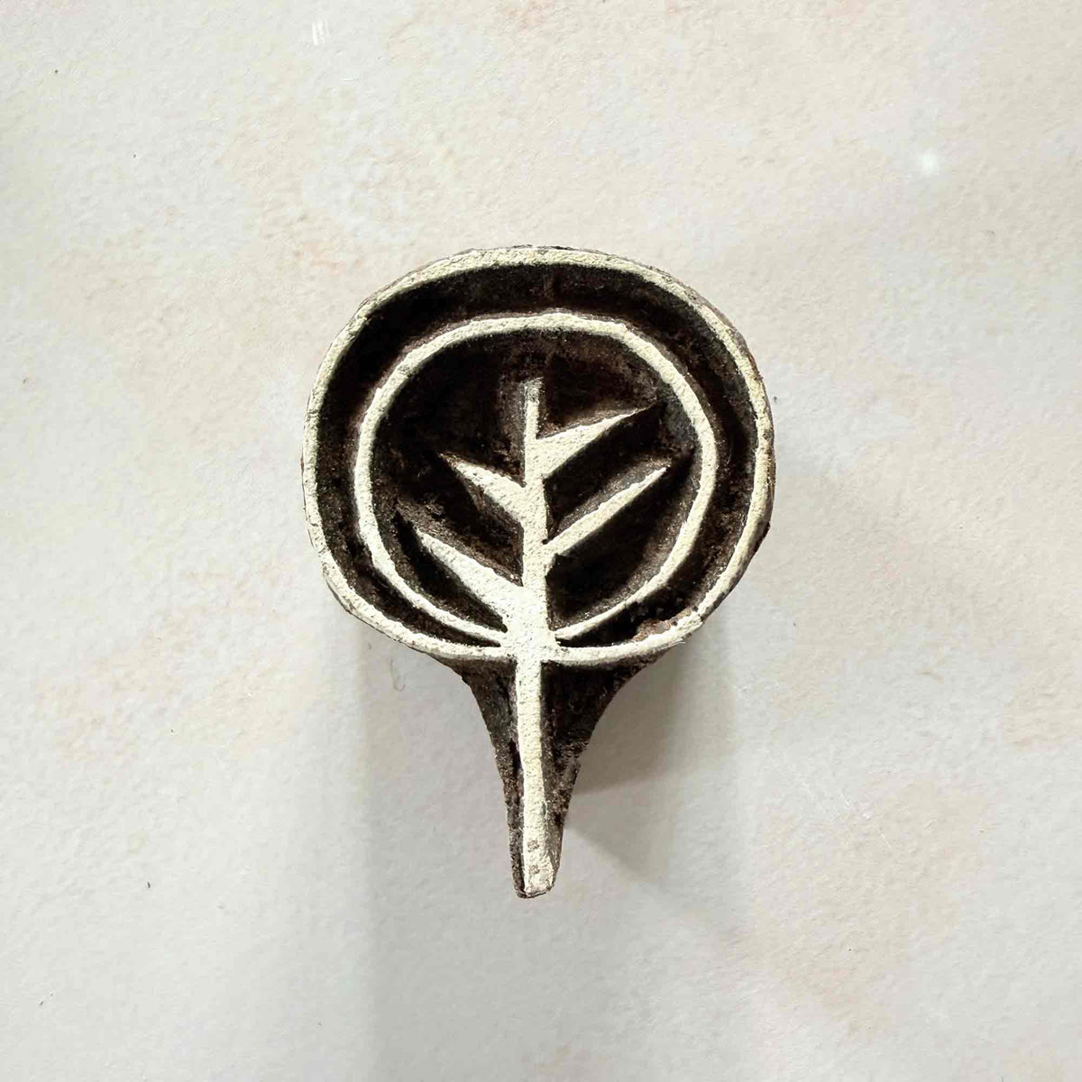 Ankur botanical Wooden Stamp with a stylised leafy sprig inside a rounded hand-carved frame.