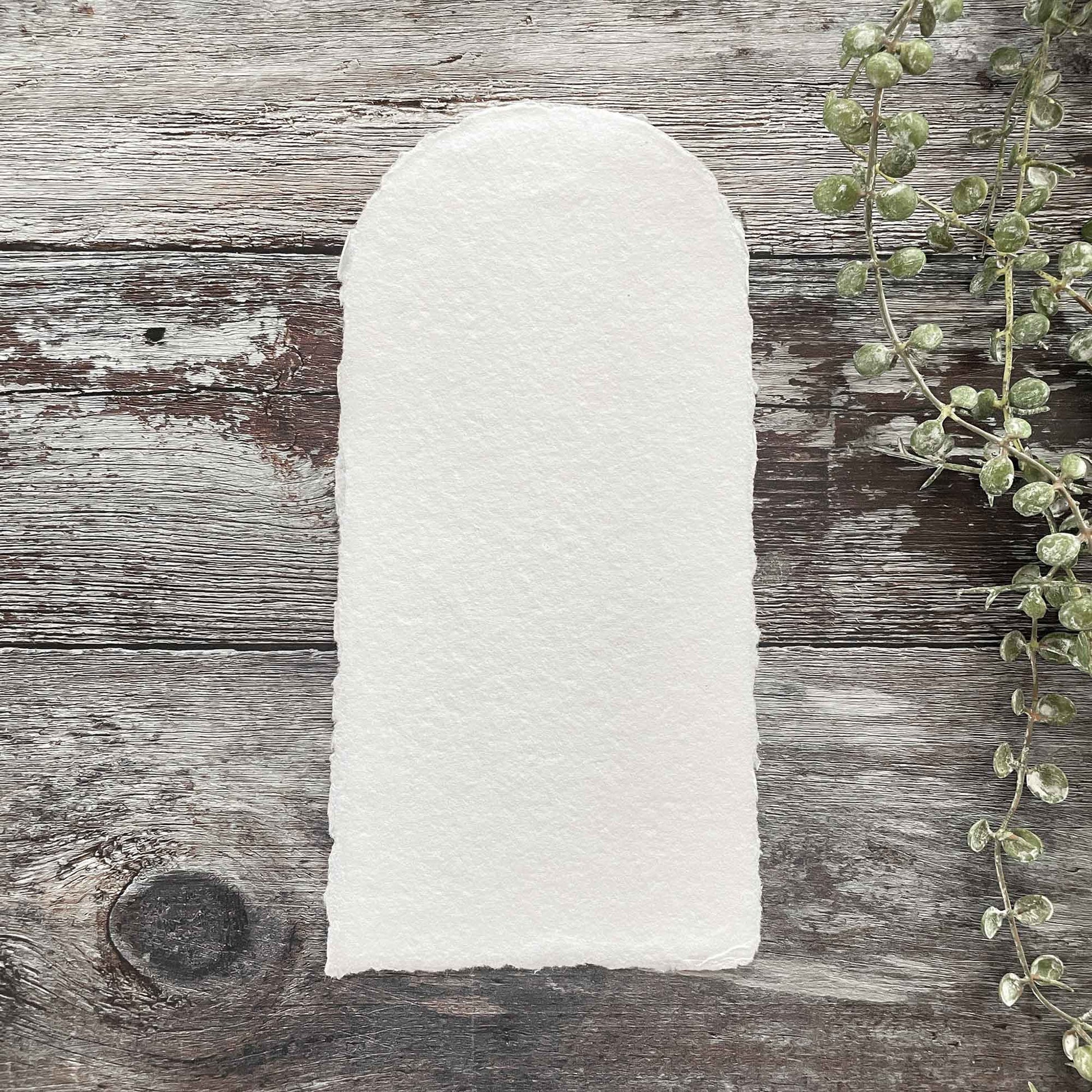 Arch shaped card made from handmade paper.  Recycled cotton rag paper with a deckled edge.  Handmade paper panels for making menus, invitations etc.  Premium white colour.  By The Natural Paper Company