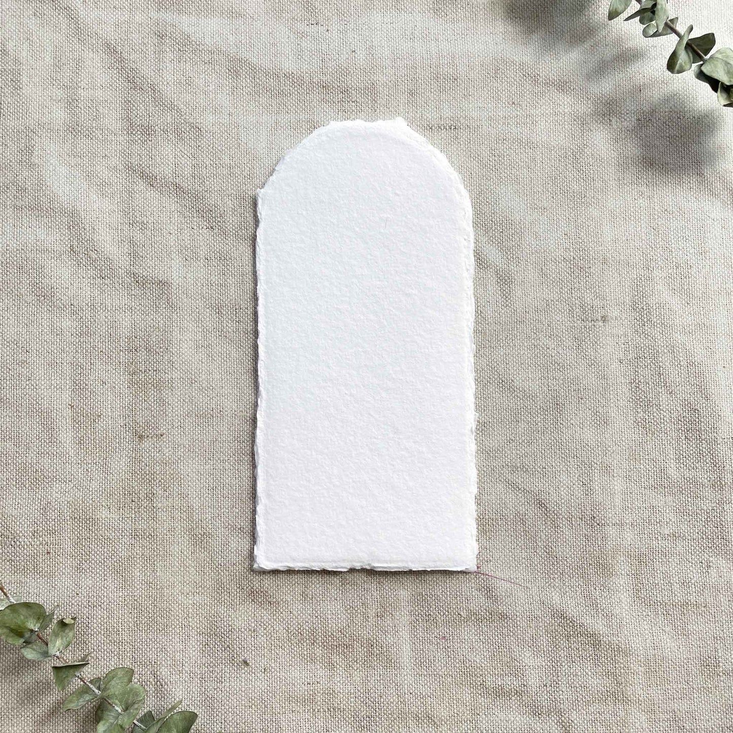 Arch shaped card made from white recycled cotton rag paper with deckled edges