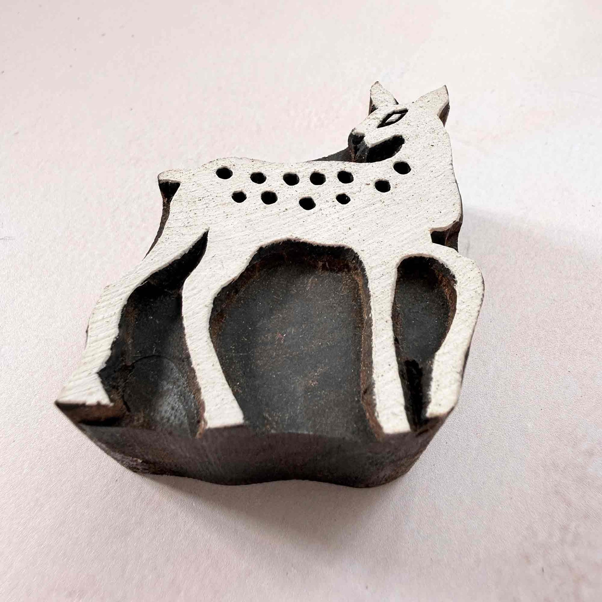 Indian wood block stamp — Bambi spotted deer viewed from side, showing carved depth and smooth fawn outline texture, handcrafted wooden stamp, premium traditional printing block hardwood