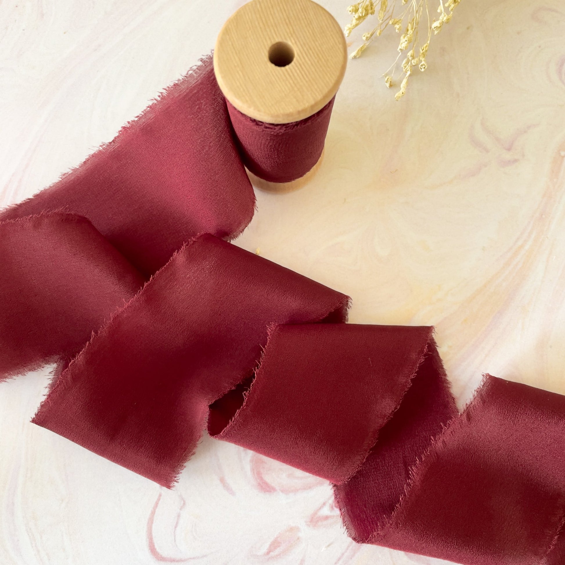 Luxury silk ribbon in burgundy.  Fine habotai silk ribbon with a frayed edge.  By The Natural Paper Company.